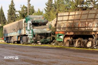 This image provided by the Syrian anti-government group Aleppo 24 news, shows damaged trucks carrying aid, in Aleppo, Syria. A U.N. humanitarian aid convoy in Syria was hit by airstrikes Monday as the Syrian military declared that a U.S.-Russian brokered cease-fire had failed, and U.N. officials reported many dead and seriously wounded. (Aleppo 24 news via AP)